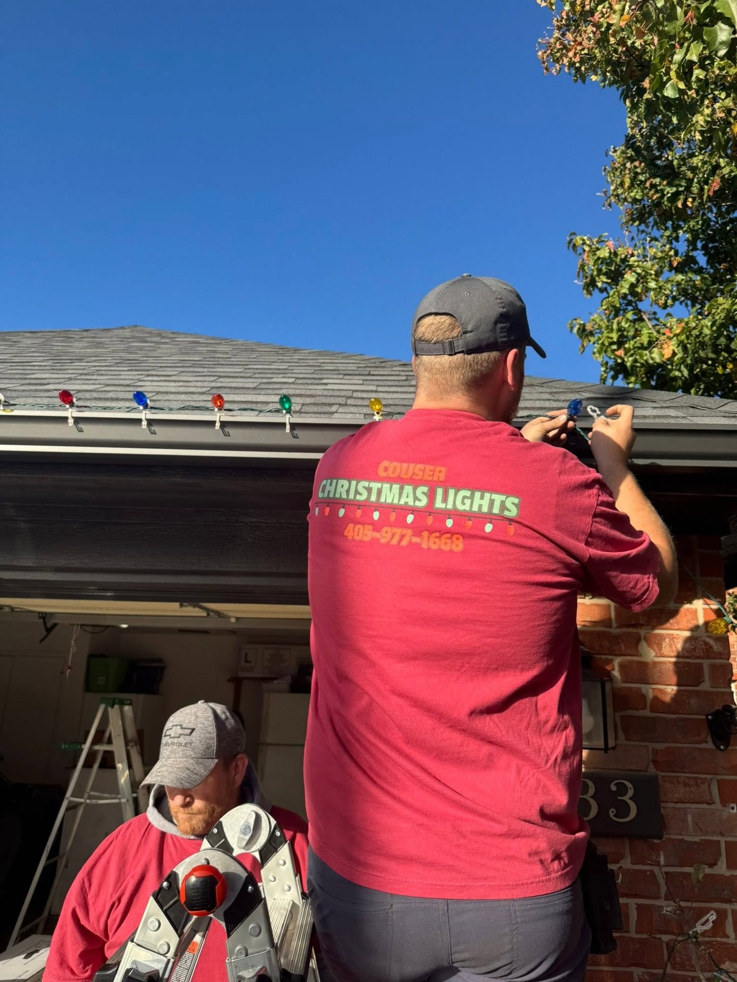 The Couser crew installing lights along a gutter