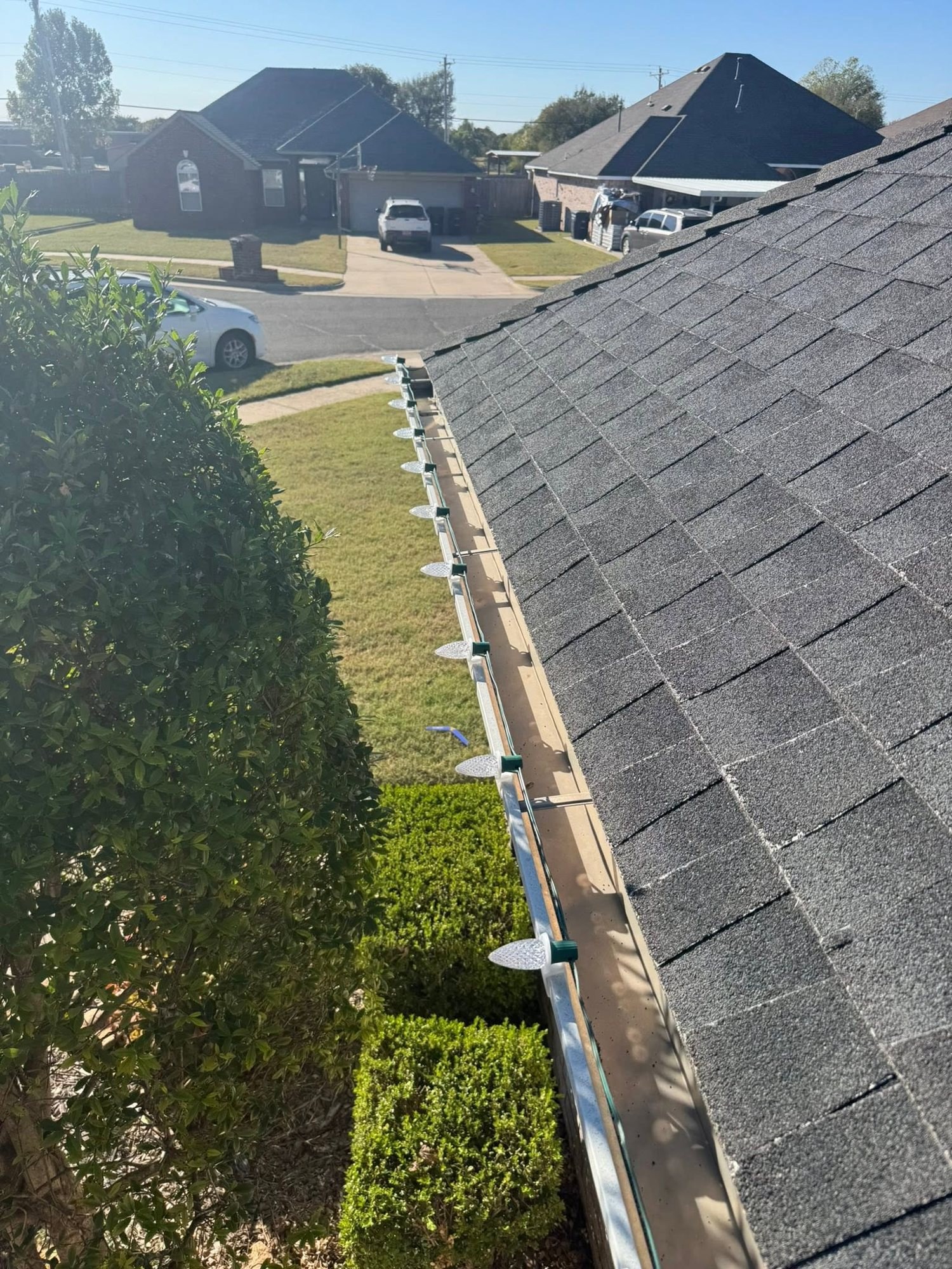 C9 light clips and bulb bases along a gutter in daylight