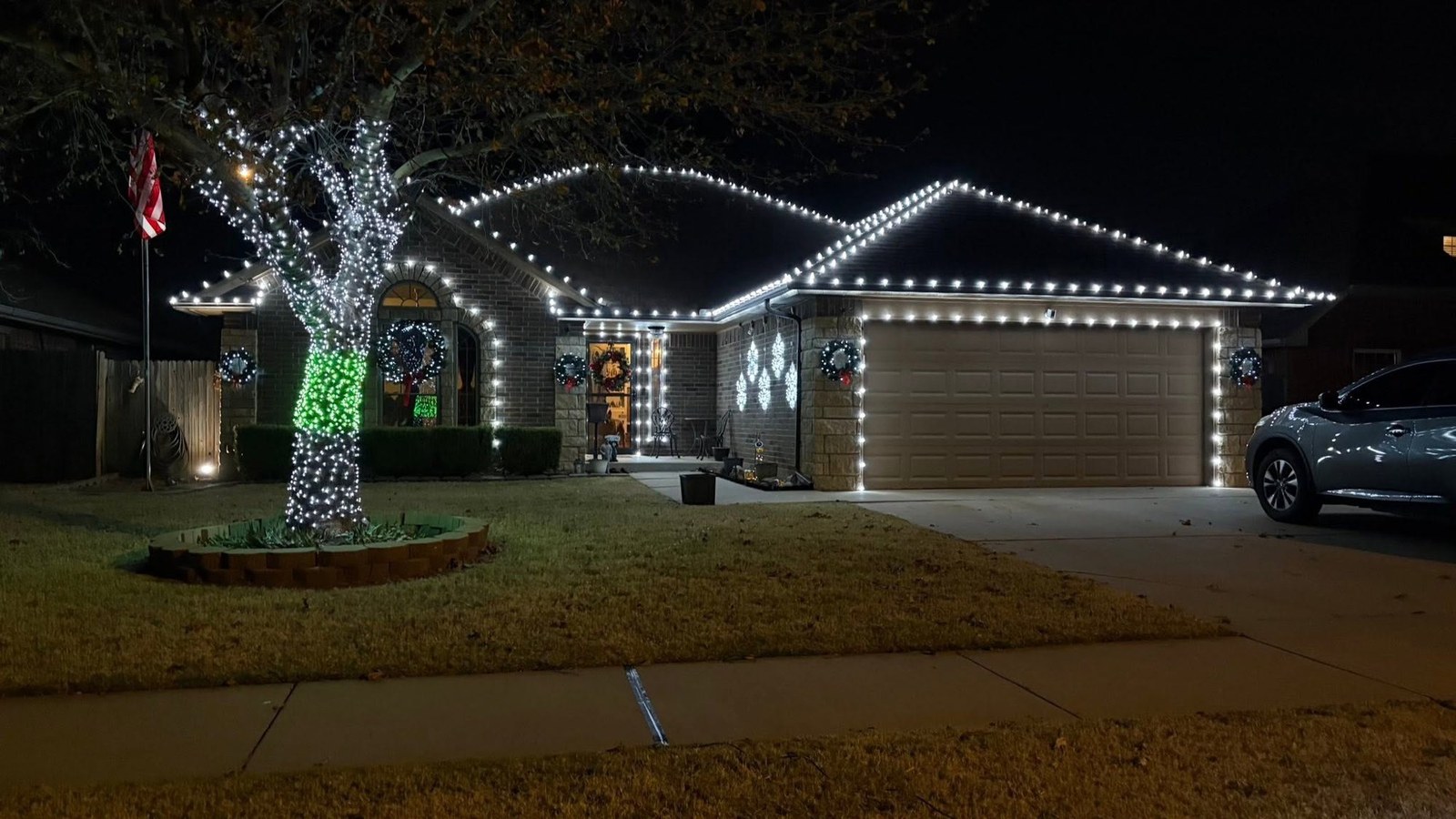 White roofline with a white and green wrapped tree